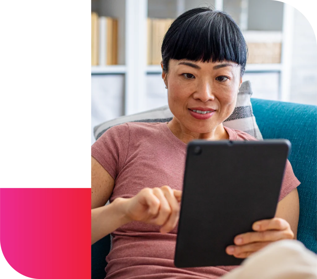 A woman uses a digital tablet at home